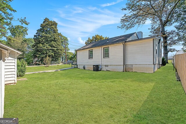 exterior space with a lawn and central air condition unit