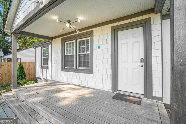 doorway to property with a deck and ceiling fan