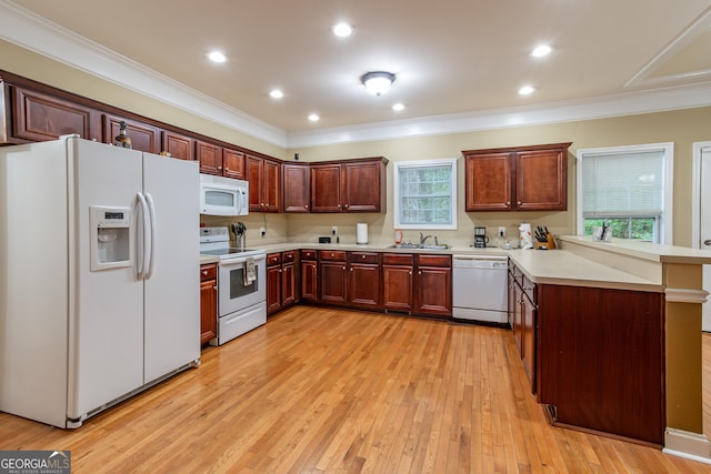 kitchen with kitchen peninsula, white appliances, ornamental molding, light hardwood / wood-style flooring, and sink