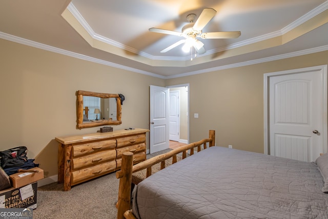 carpeted bedroom featuring ceiling fan, ornamental molding, and a raised ceiling