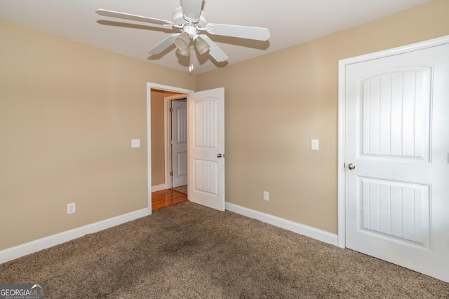 unfurnished bedroom featuring ceiling fan and carpet flooring