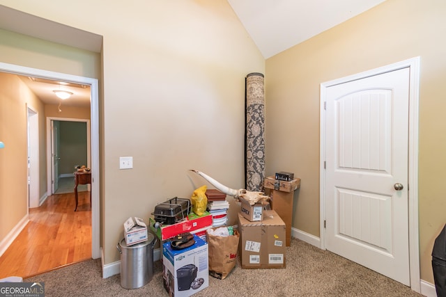 interior space featuring vaulted ceiling and carpet floors