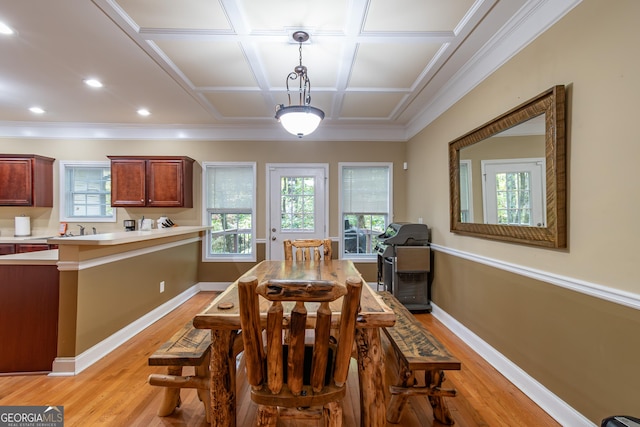 dining space featuring light hardwood / wood-style floors, coffered ceiling, and sink