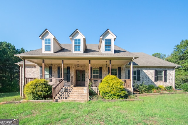 view of front of house featuring covered porch and a front yard