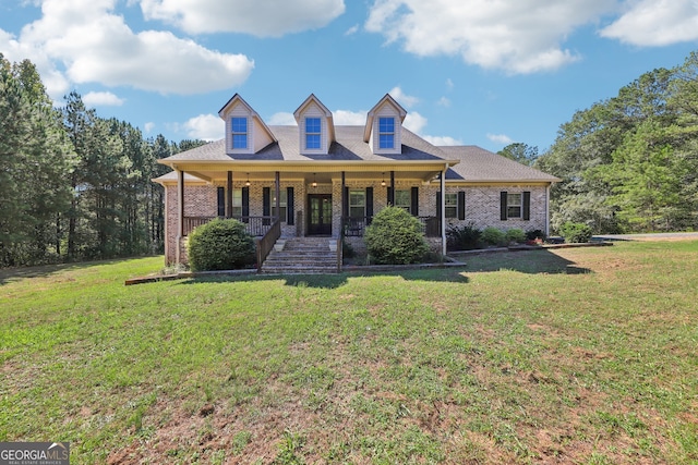 new england style home with covered porch and a front yard