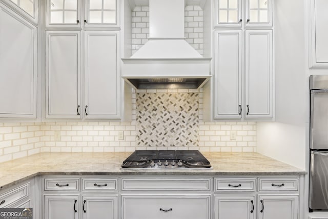 kitchen featuring white cabinets, appliances with stainless steel finishes, and backsplash