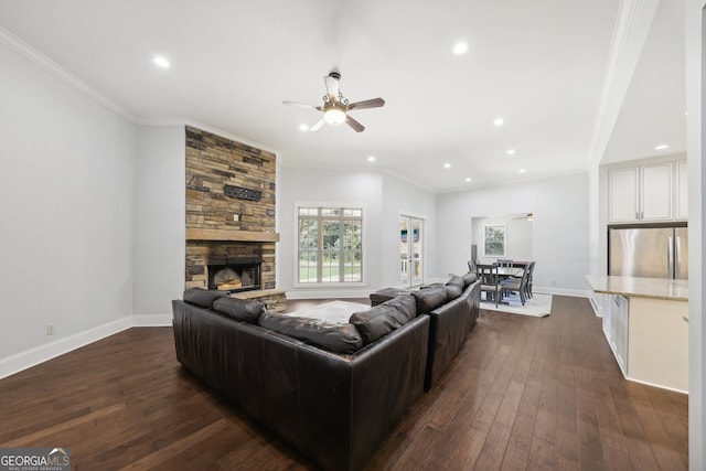 living room featuring a fireplace, ceiling fan, dark hardwood / wood-style floors, and crown molding