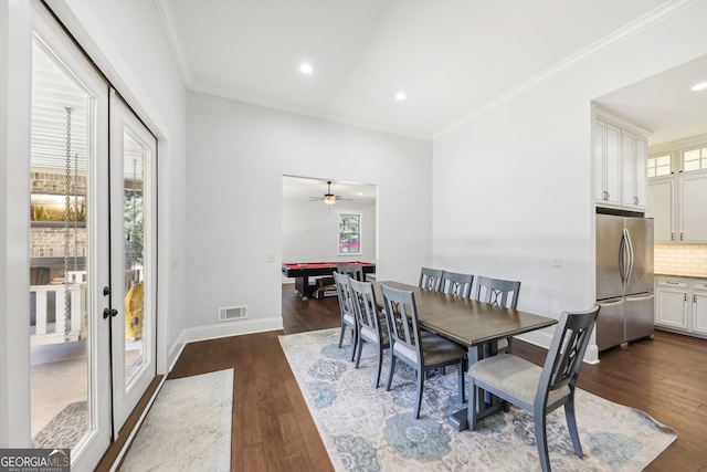 dining room featuring dark hardwood / wood-style flooring, ceiling fan, ornamental molding, and a healthy amount of sunlight