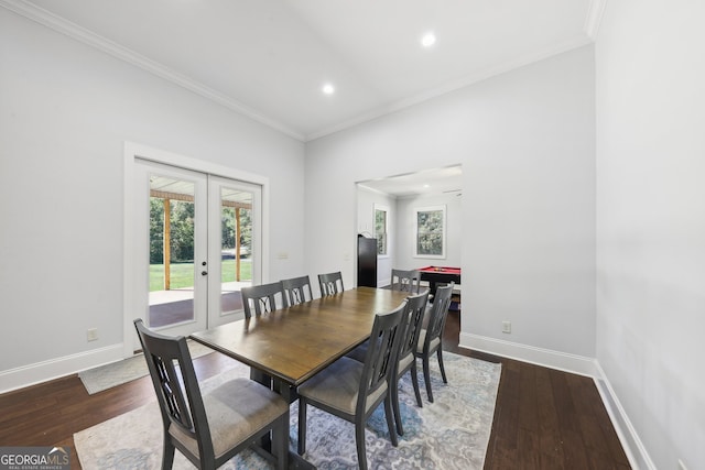 dining space with dark wood-type flooring, french doors, and ornamental molding