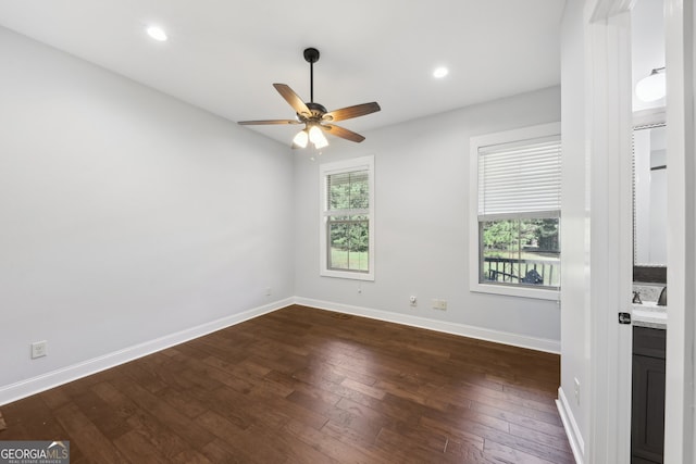 spare room with ceiling fan and dark hardwood / wood-style floors