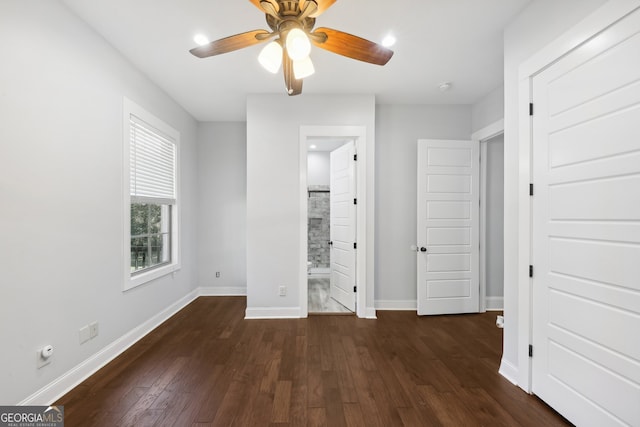 unfurnished bedroom with ceiling fan, dark hardwood / wood-style floors, and ensuite bath