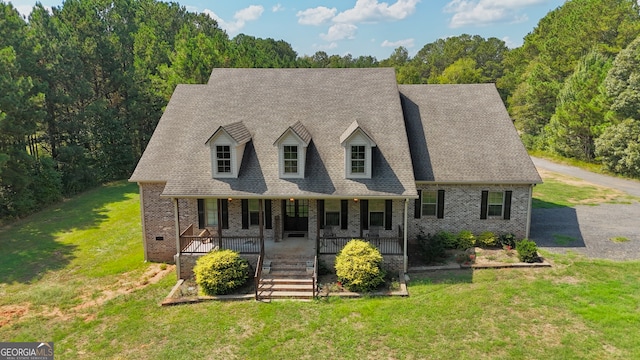 view of front of house with a front yard and covered porch