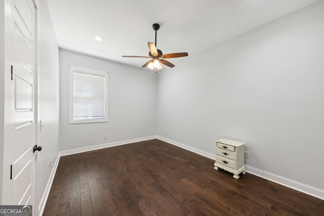 spare room featuring ceiling fan and dark hardwood / wood-style floors