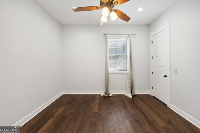 unfurnished room featuring dark hardwood / wood-style floors and ceiling fan