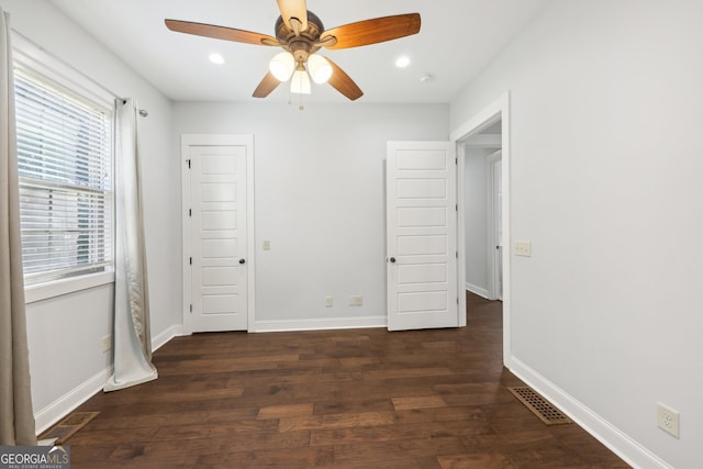 unfurnished bedroom with dark wood-type flooring and ceiling fan