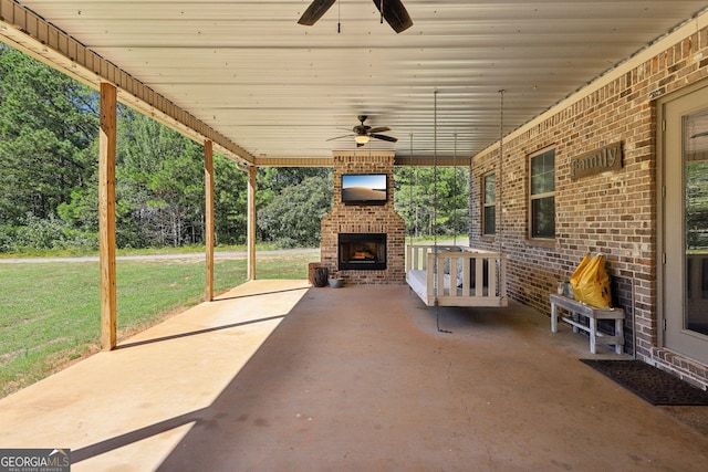 view of patio with ceiling fan and an outdoor brick fireplace