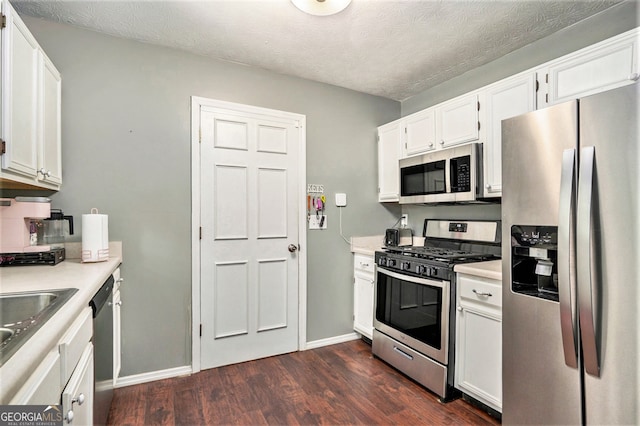 kitchen featuring stainless steel appliances, dark hardwood / wood-style floors, and white cabinetry