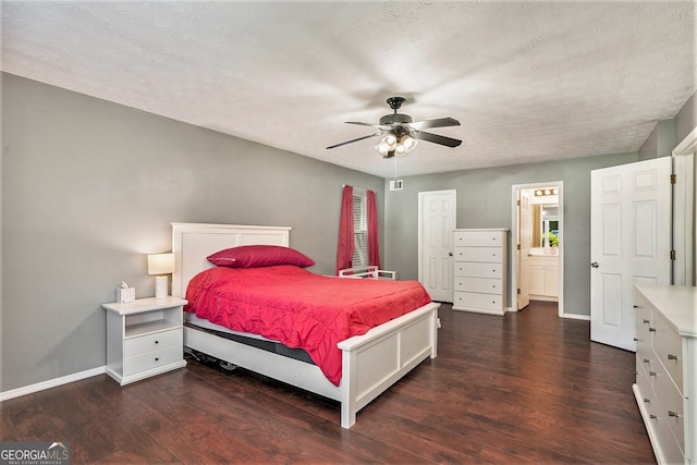 bedroom featuring ceiling fan, a textured ceiling, ensuite bath, and dark hardwood / wood-style flooring