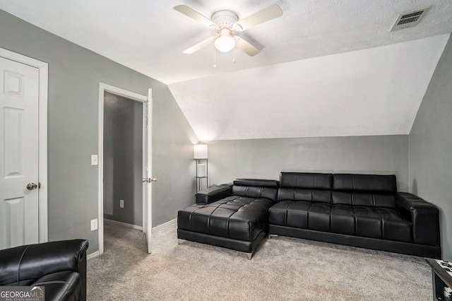 living room with ceiling fan, light colored carpet, a textured ceiling, and lofted ceiling