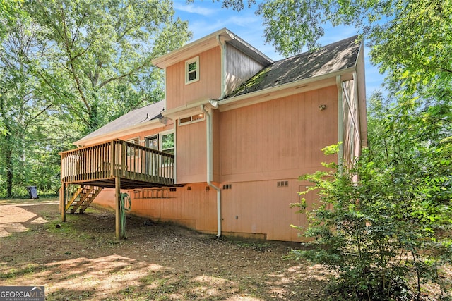 view of property exterior with a deck