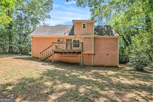 back of property featuring a wooden deck