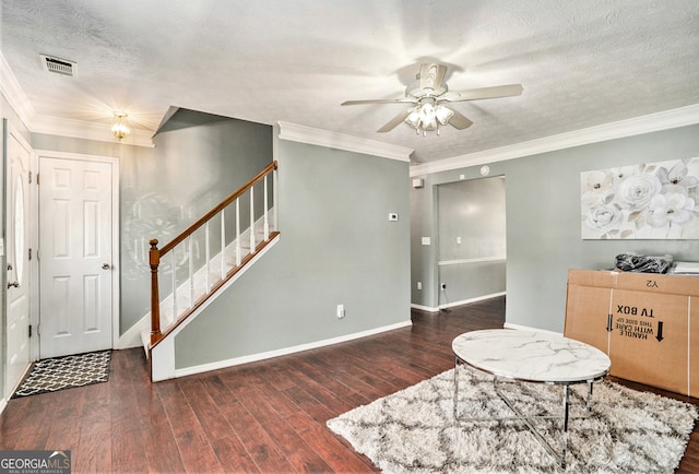 interior space with a textured ceiling, ornamental molding, dark hardwood / wood-style flooring, and ceiling fan