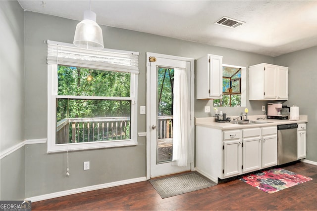 kitchen featuring hanging light fixtures, white cabinetry, dark wood-type flooring, stainless steel dishwasher, and sink