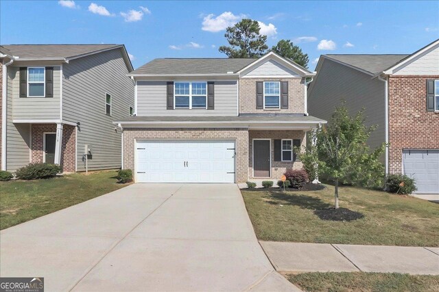 view of front of home with a garage and a front lawn