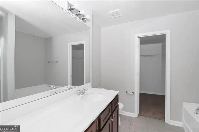 full bathroom with tile patterned flooring, shower / tub combination, vanity, and toilet