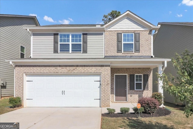 view of front of home with a garage, brick siding, and driveway