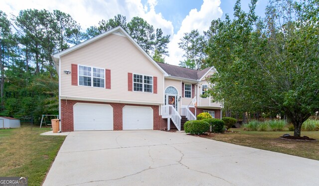 bi-level home featuring a front yard and a garage