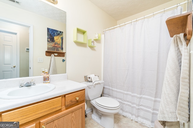 bathroom featuring vanity, a textured ceiling, tile patterned flooring, toilet, and a shower with curtain