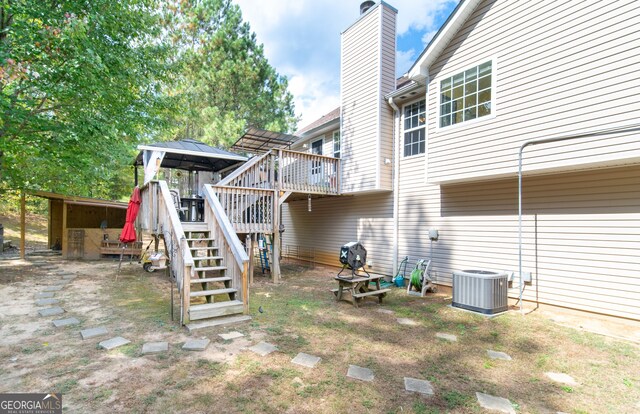 view of yard with a deck and central AC