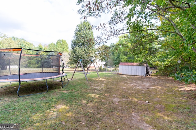 view of yard with a playground, a trampoline, and a shed