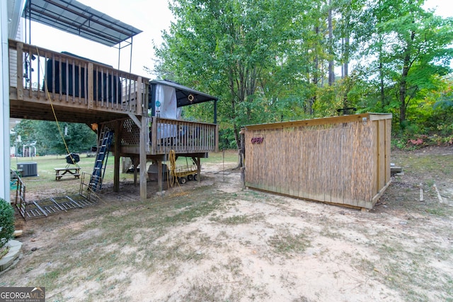 view of yard featuring cooling unit and a wooden deck