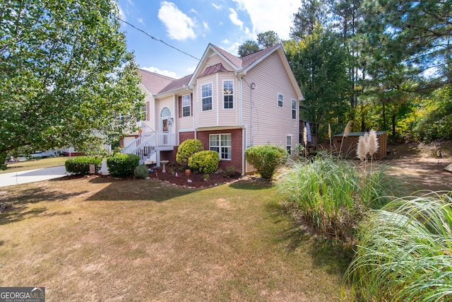 view of side of property with a lawn