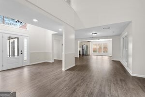 interior space featuring vaulted ceiling with beams and light colored carpet