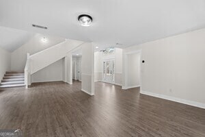 unfurnished living room featuring dark wood-type flooring