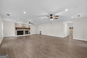 kitchen with decorative light fixtures, plenty of natural light, stainless steel appliances, and dark hardwood / wood-style floors