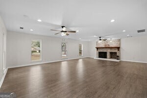 kitchen with appliances with stainless steel finishes, pendant lighting, cream cabinets, dark hardwood / wood-style floors, and sink