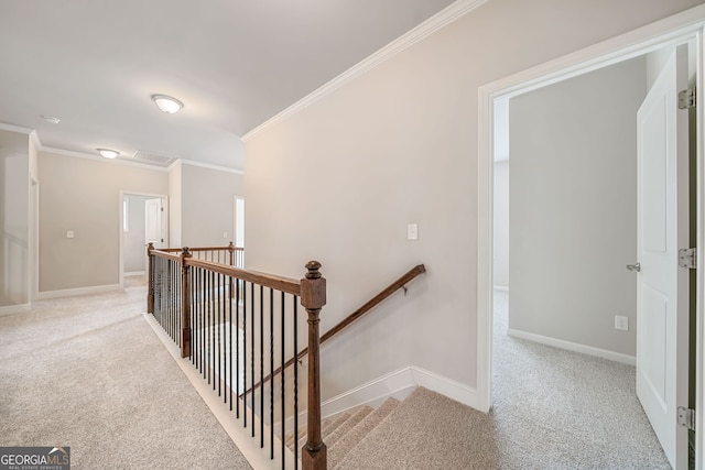 stairway with visible vents, baseboards, carpet, and ornamental molding