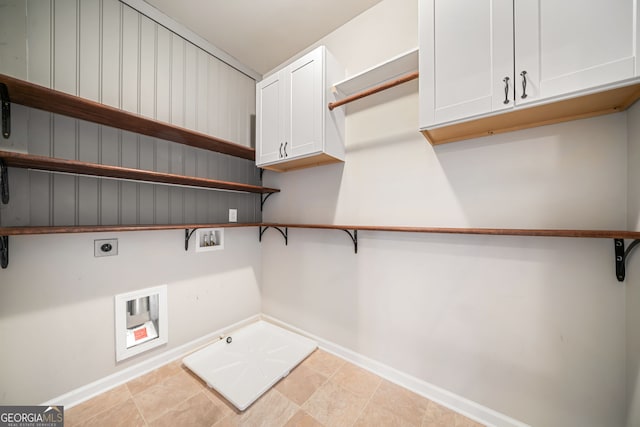 washroom featuring hookup for a washing machine, baseboards, gas dryer hookup, cabinet space, and electric dryer hookup
