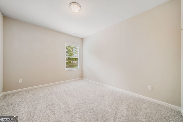 empty room with visible vents, baseboards, and carpet floors