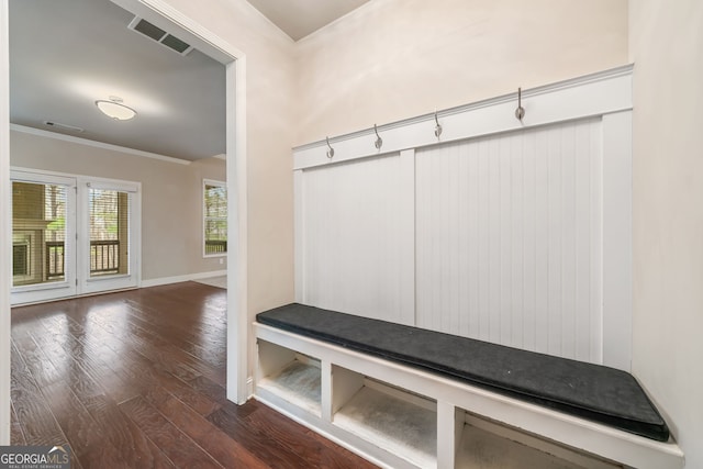 mudroom featuring visible vents, baseboards, dark wood-style floors, and crown molding