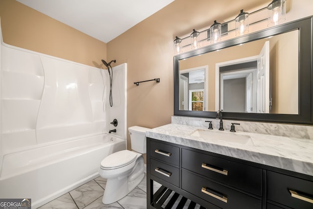 bathroom with vanity, toilet, marble finish floor, and  shower combination