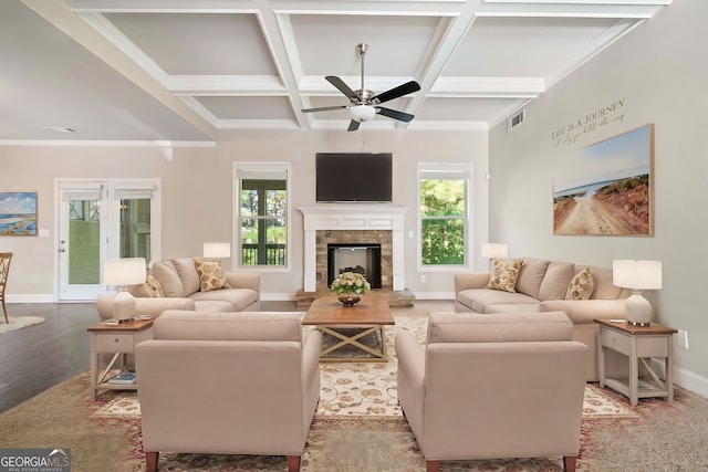 living area featuring coffered ceiling, visible vents, a wealth of natural light, and ceiling fan