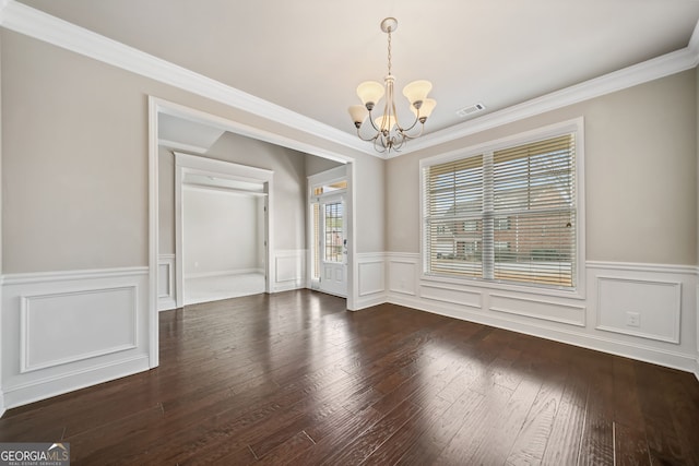 unfurnished dining area with visible vents, a wainscoted wall, dark wood finished floors, an inviting chandelier, and crown molding