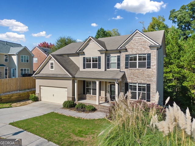 view of front of property featuring driveway, fence, covered porch, a garage, and brick siding