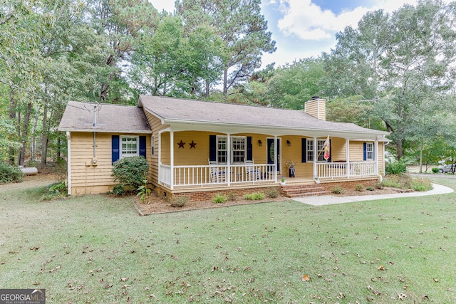 single story home with covered porch and a front lawn