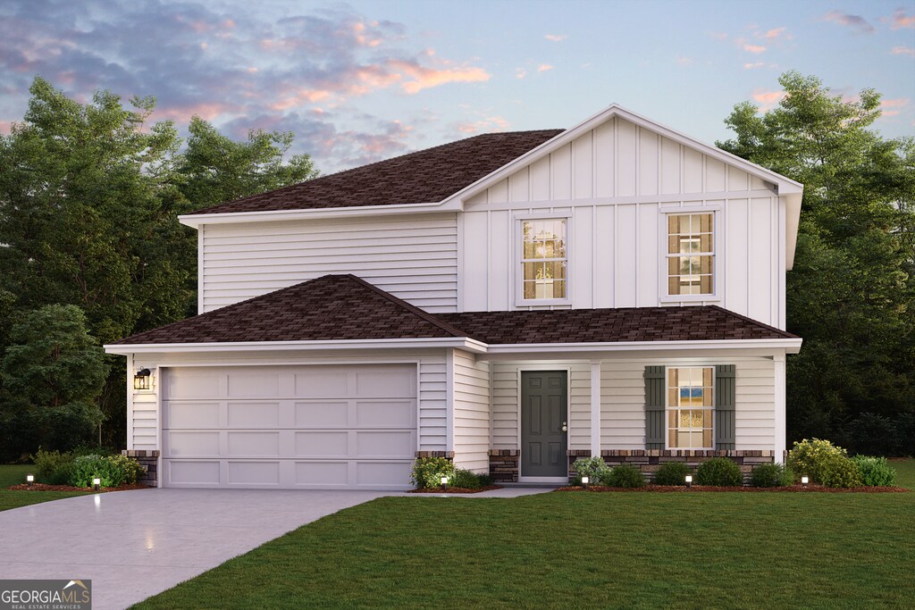 view of front of home with a garage, a yard, and covered porch